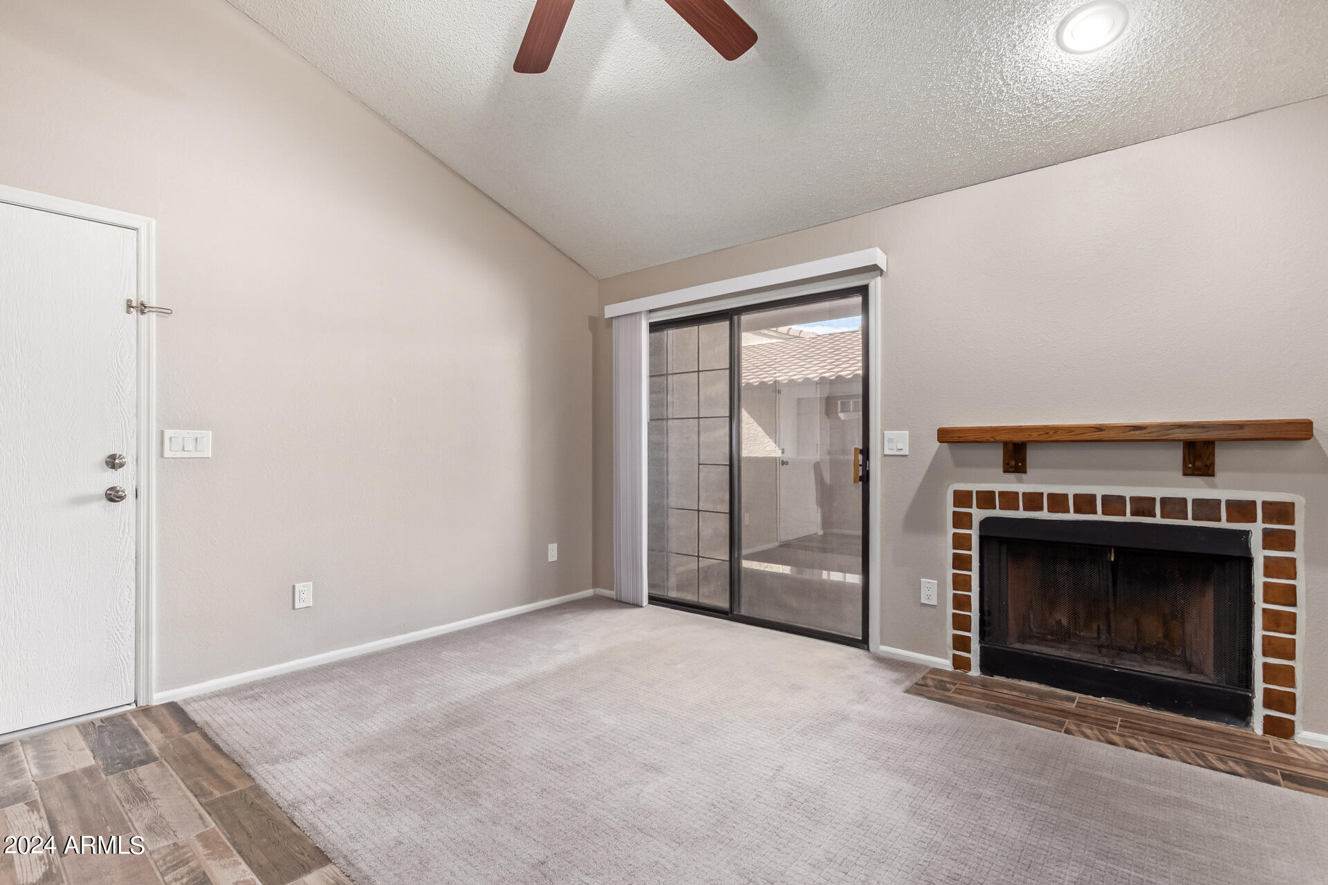 533 West Guadalupe Road, Unit 2046 Mesa, AZ 85210 - Photo 3 of 29 an empty room with fireplace