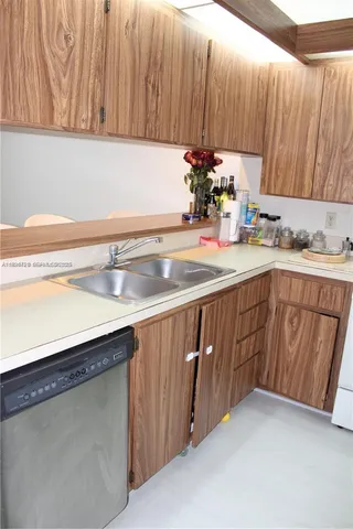a kitchen with a sink and cabinets
