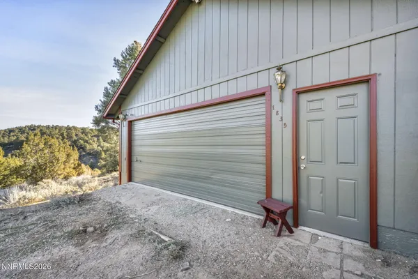 a view of a house with a backyard and wooden fence