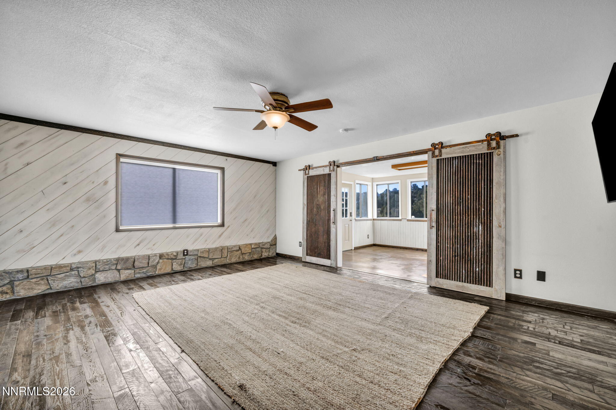 1835 Lousetown Road Reno, NV 89521 - Photo 21 of 60 a view of an empty room with window and wooden floor