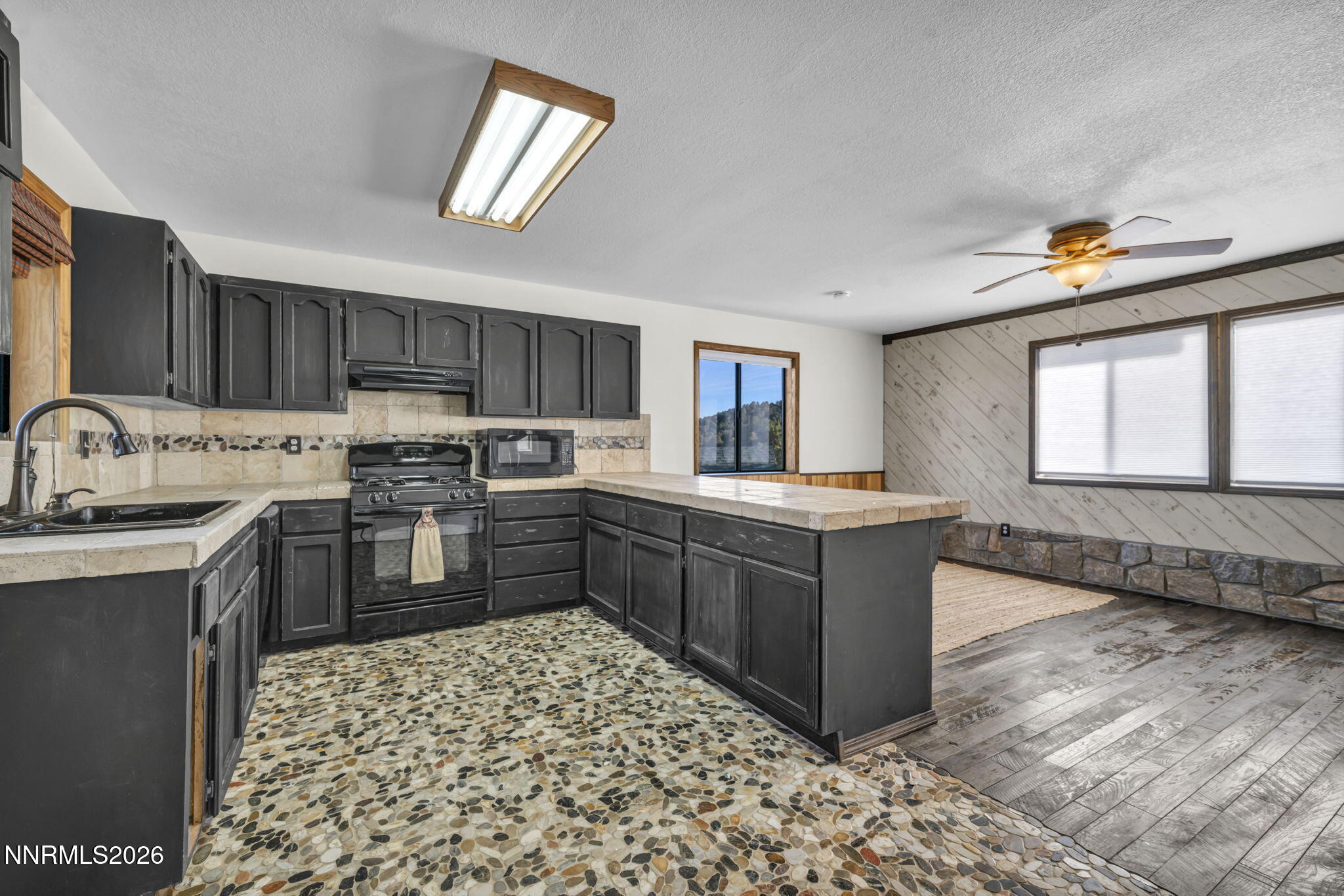 1835 Lousetown Road Reno, NV 89521 - Photo 34 of 60 a kitchen with stainless steel appliances kitchen island granite countertop a sink stove and cabinets