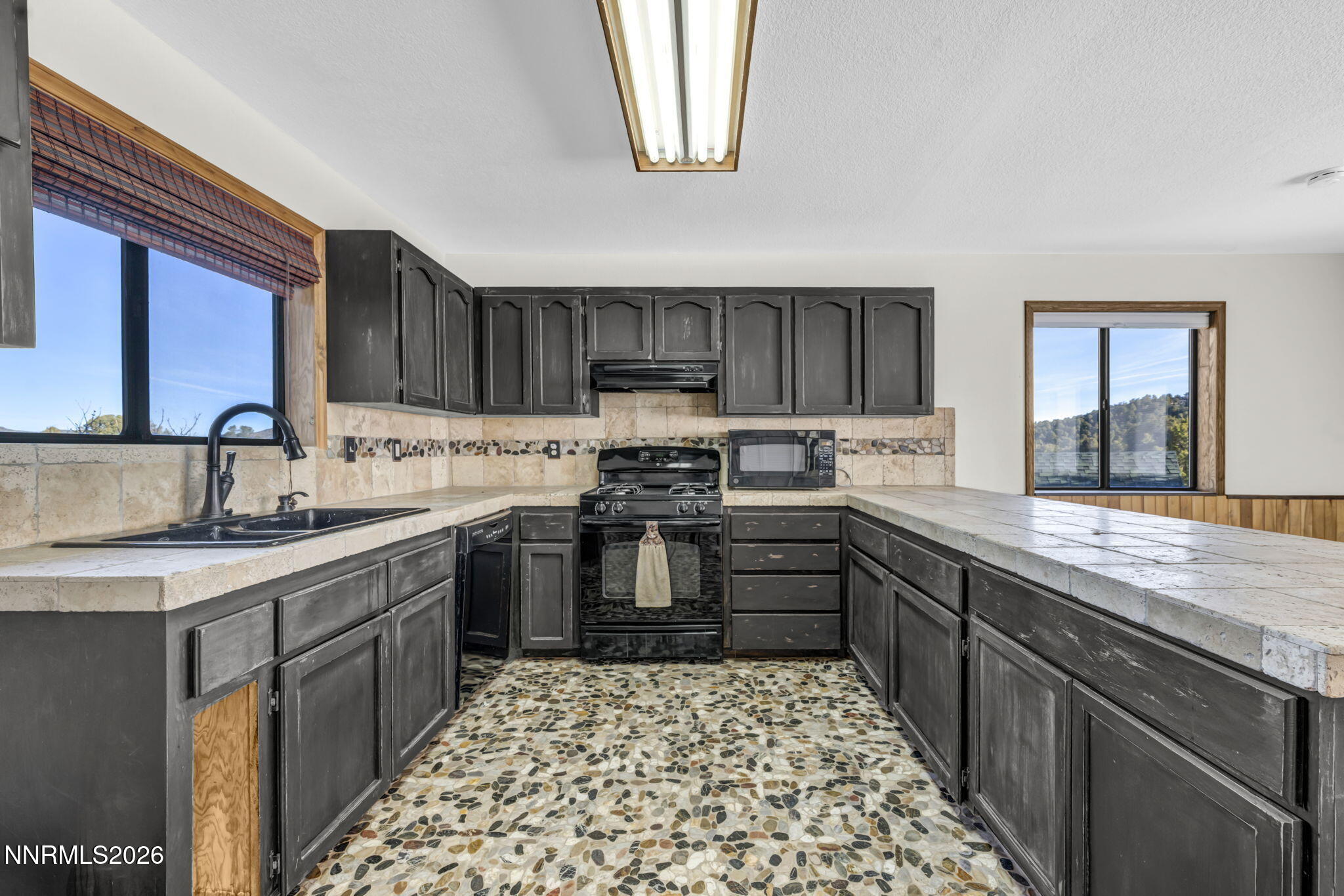 1835 Lousetown Road Reno, NV 89521 - Photo 35 of 60 a kitchen with stainless steel appliances granite countertop a stove sink and cabinets