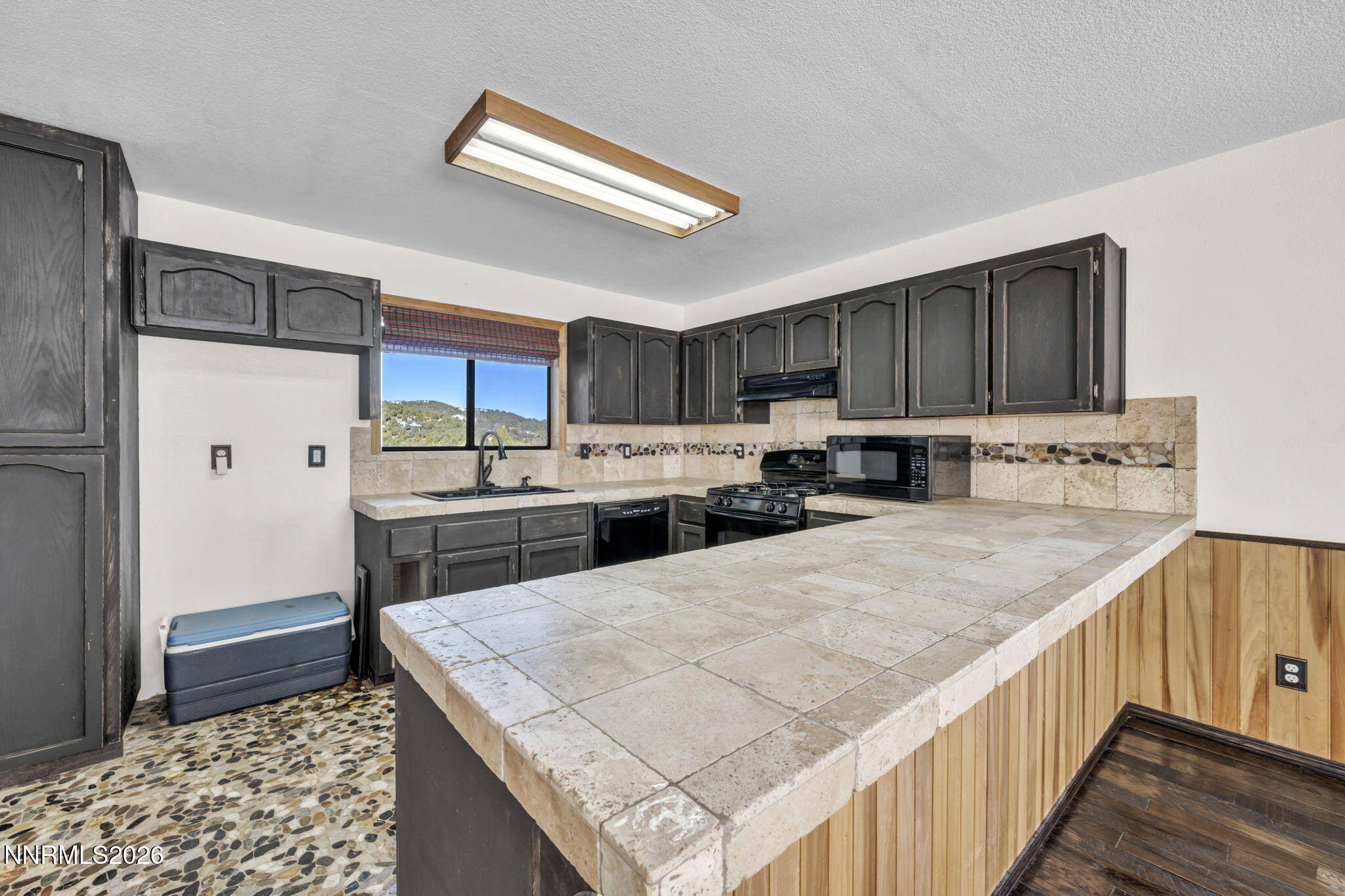 1835 Lousetown Road Reno, NV 89521 - Photo 36 of 60 a kitchen with stainless steel appliances kitchen island a stove a refrigerator and a sink