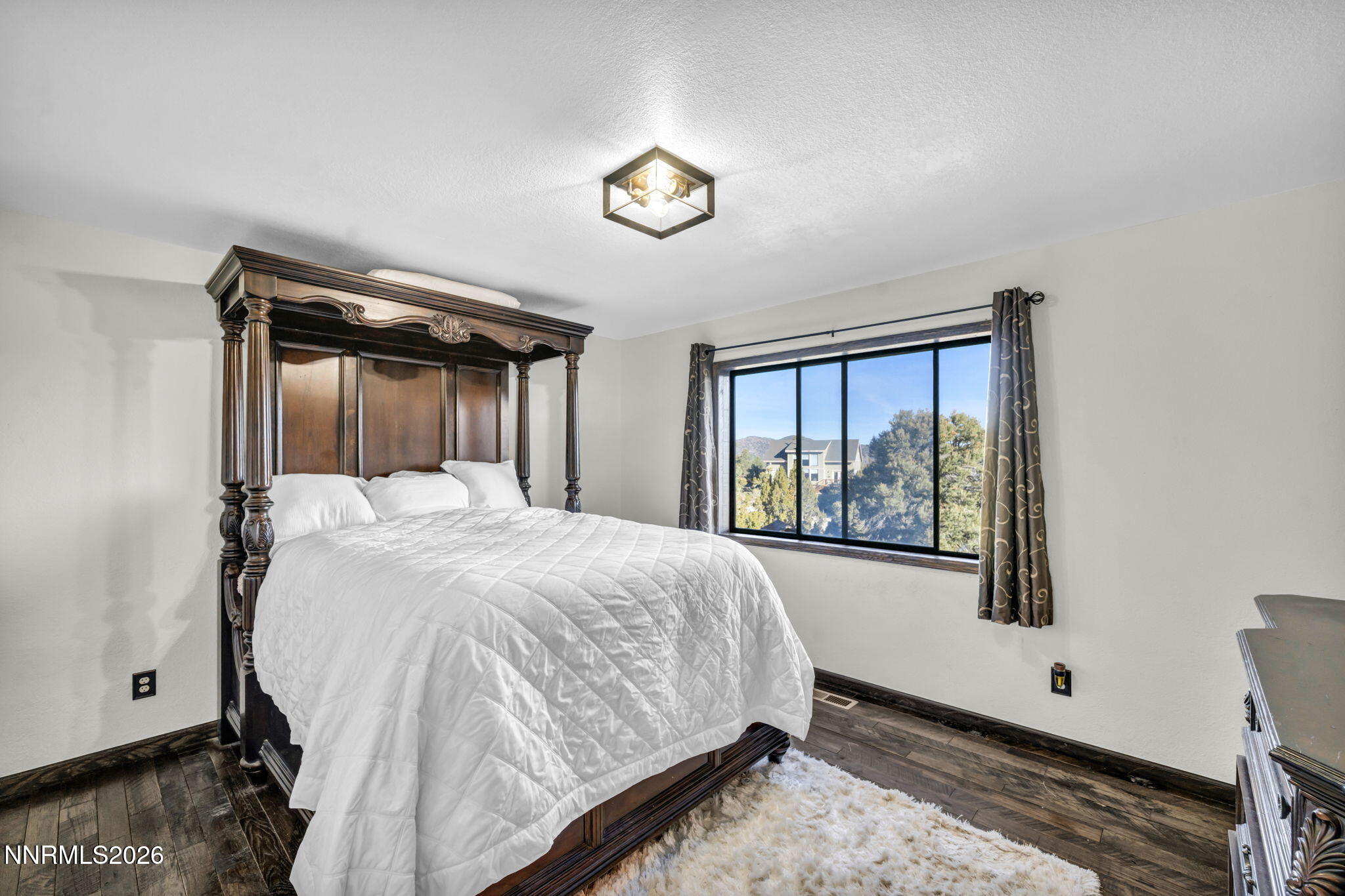 1835 Lousetown Road Reno, NV 89521 - Photo 40 of 60 a bed sitting in a bedroom next to a window