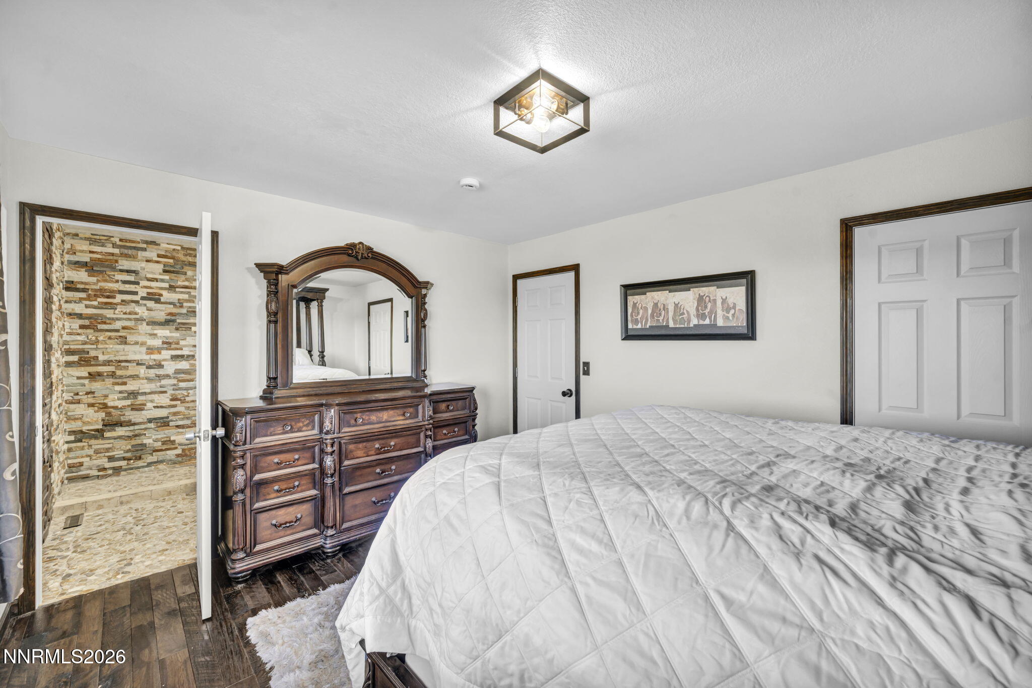 1835 Lousetown Road Reno, NV 89521 - Photo 41 of 60 a bedroom with a bed and dresser with mirror