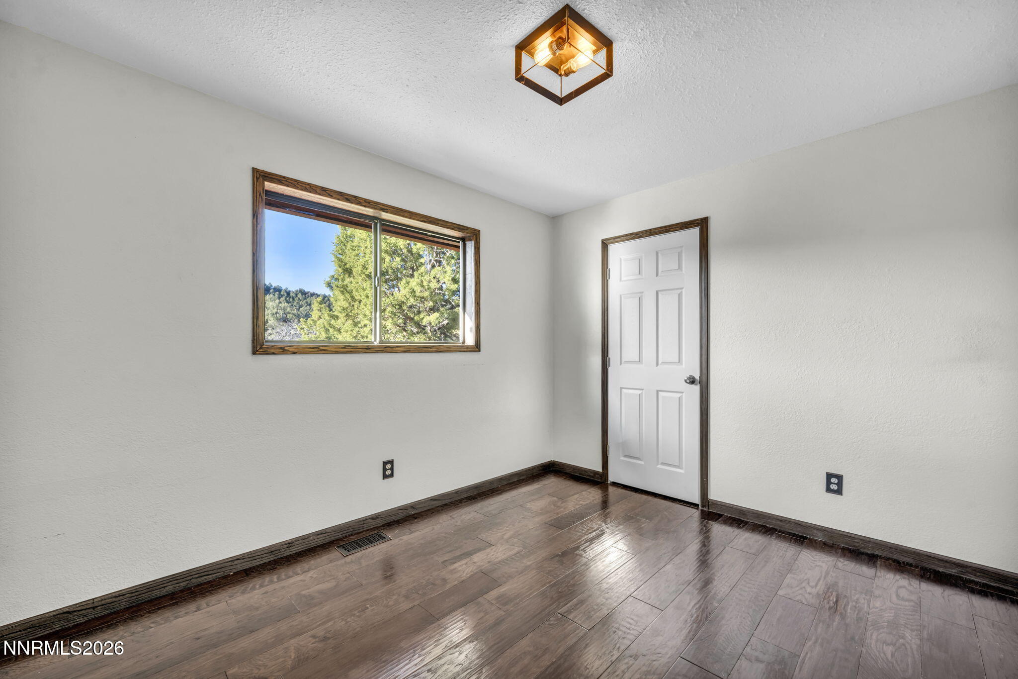 1835 Lousetown Road Reno, NV 89521 - Photo 46 of 60 an empty room with wooden floor and windows