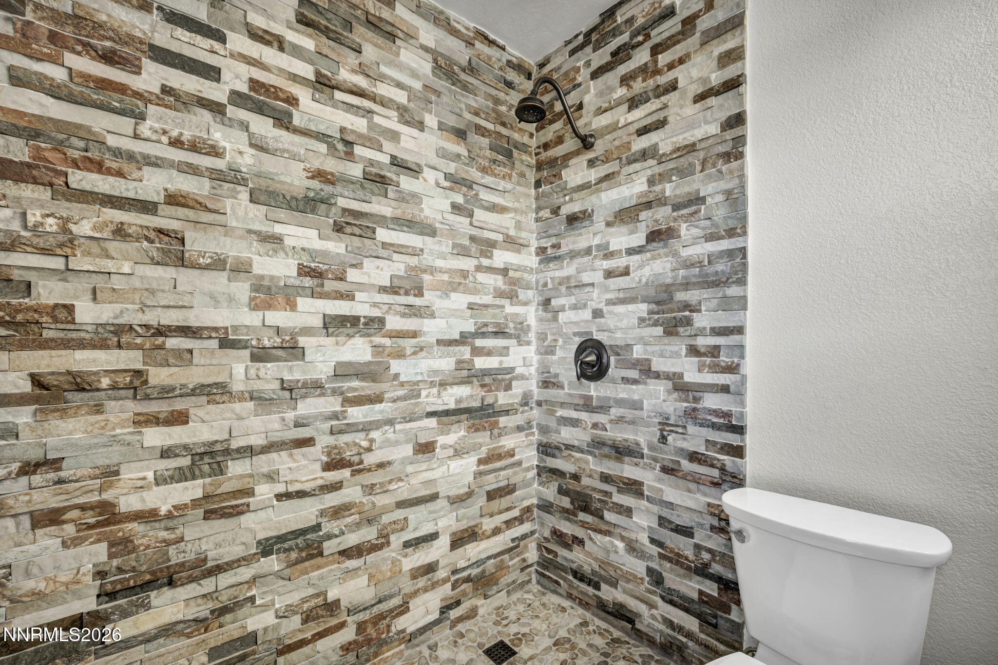 1835 Lousetown Road Reno, NV 89521 - Photo 49 of 60 a bathroom with a toilet and a shower curtain