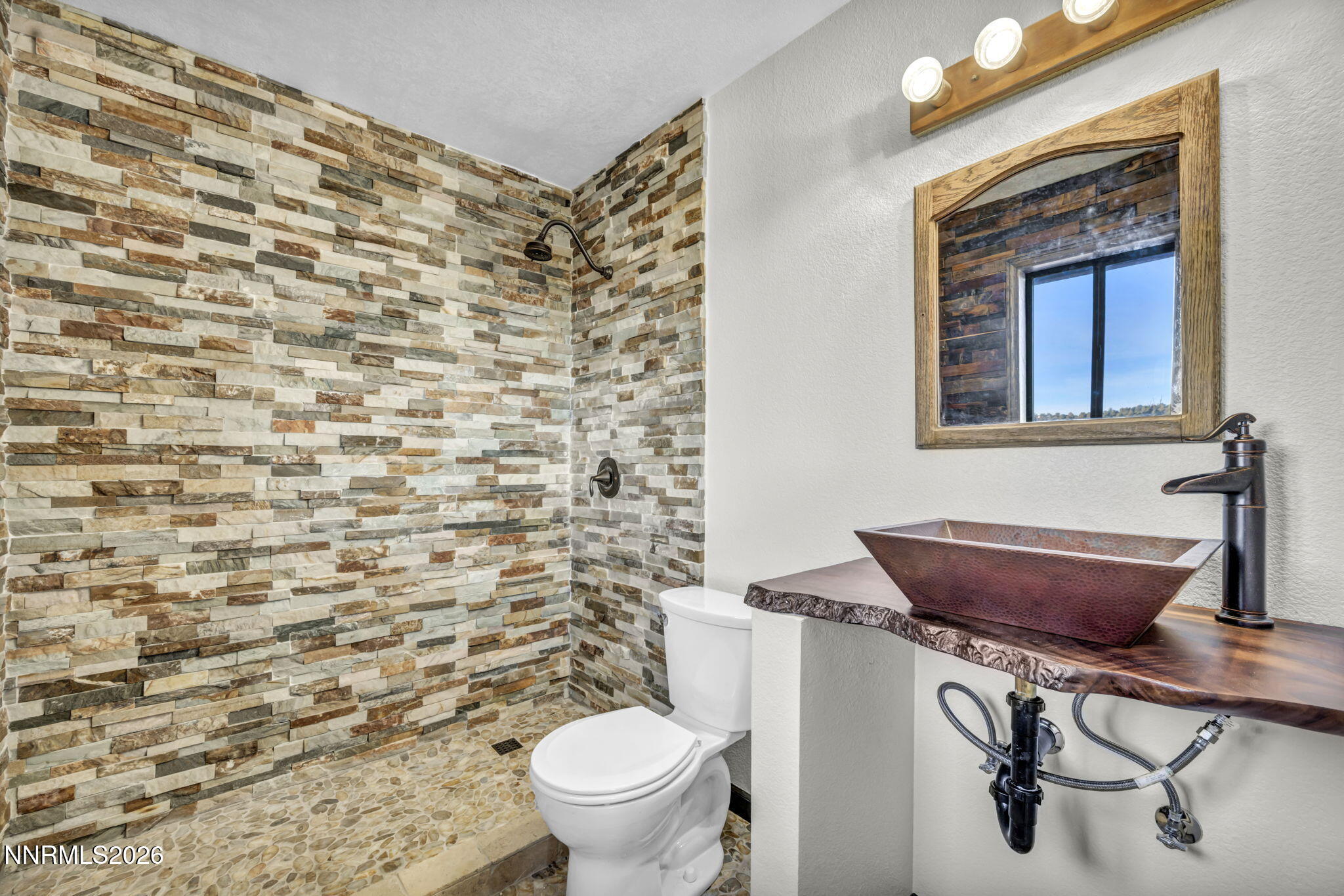 1835 Lousetown Road Reno, NV 89521 - Photo 50 of 60 a bathroom with a toilet and a shower curtain