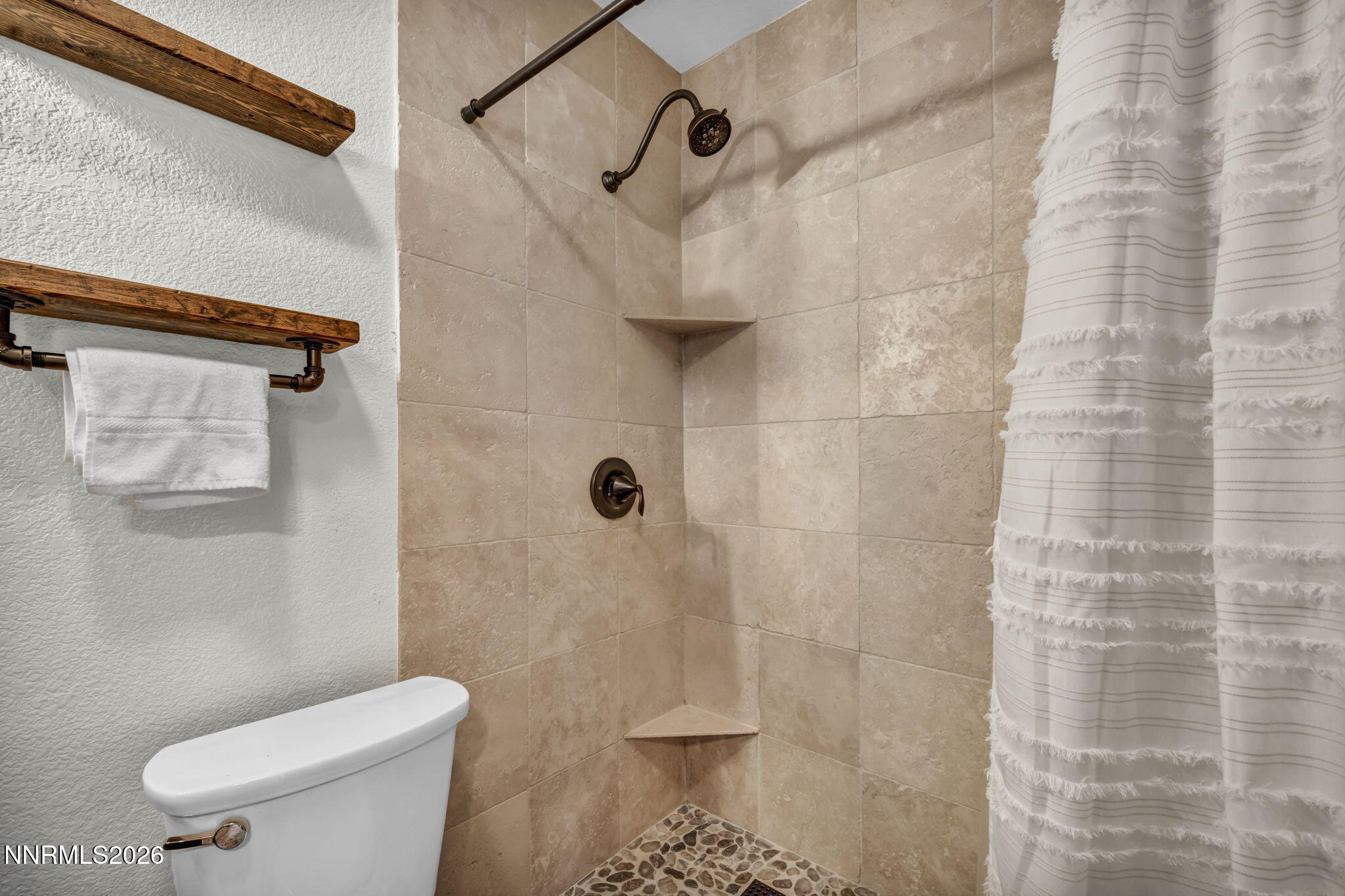 1835 Lousetown Road Reno, NV 89521 - Photo 51 of 60 a white toilet sitting next to a shower