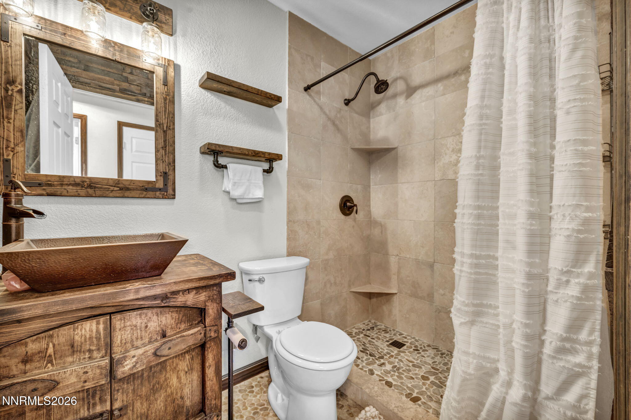 1835 Lousetown Road Reno, NV 89521 - Photo 52 of 60 a bathroom with a toilet and a shower curtain