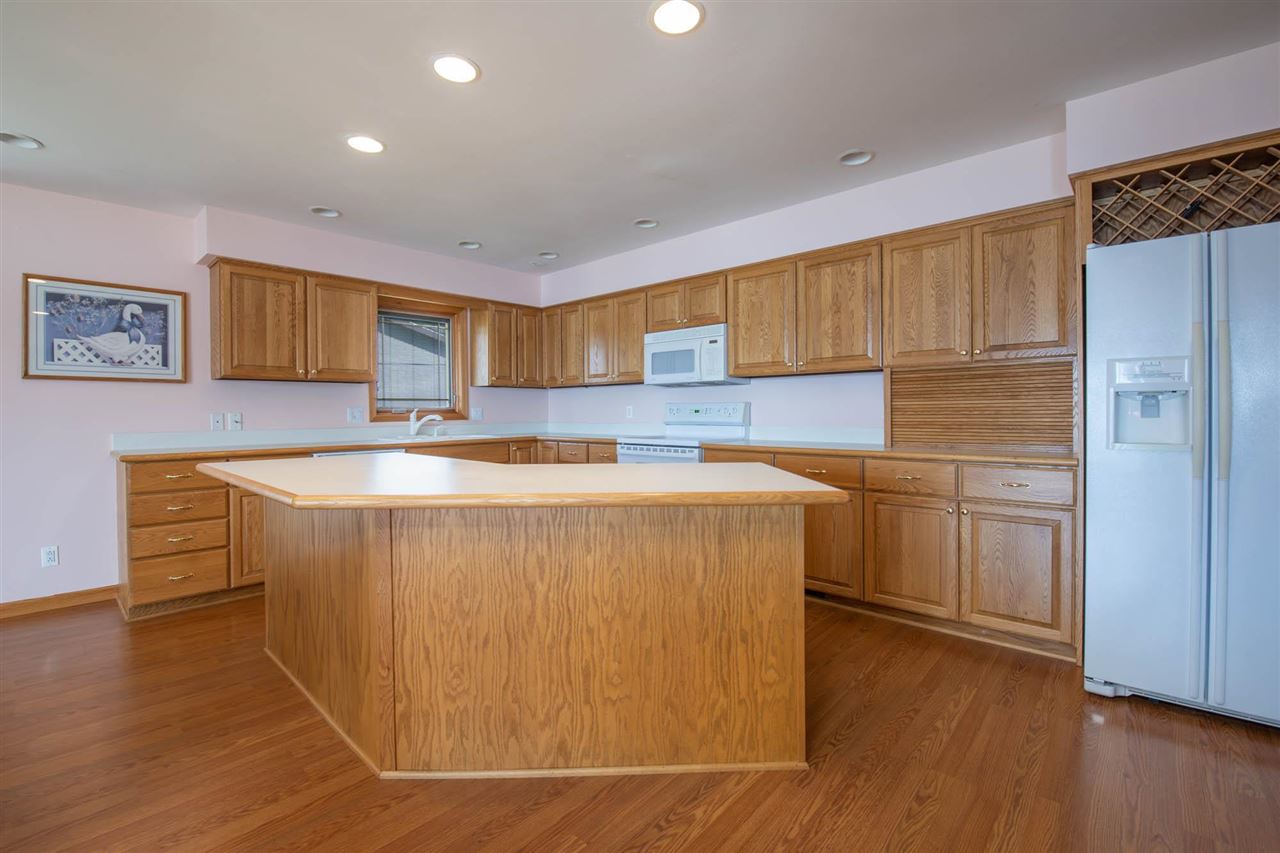 2239 Breckenboro Road Davis, IL 61019 - Photo 11 of 35 a kitchen with kitchen island a sink a stove a refrigerator and a oven
