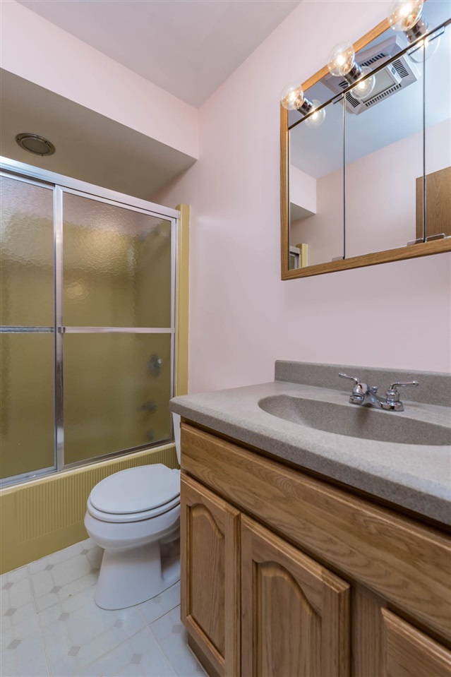 2239 Breckenboro Road Davis, IL 61019 - Photo 18 of 35 a bathroom with a granite countertop toilet sink and mirror