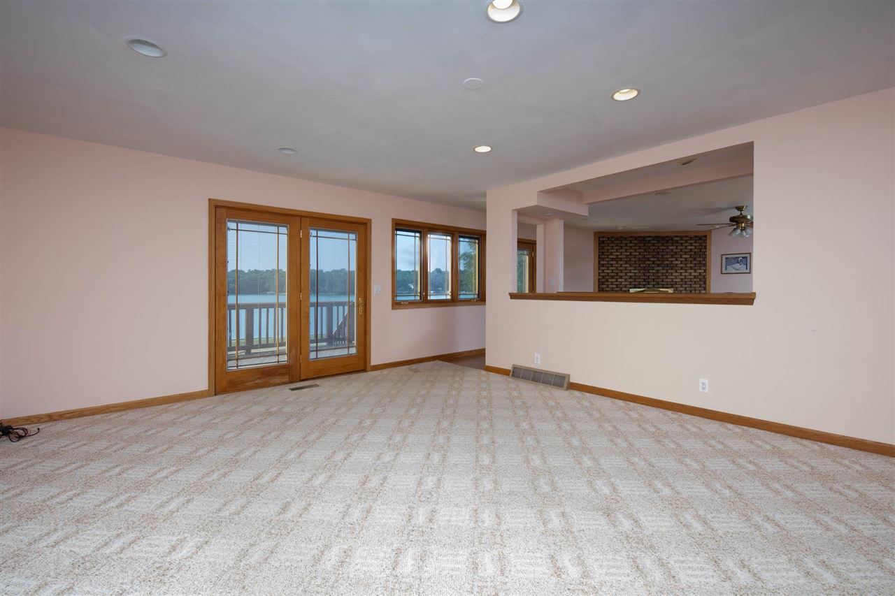 2239 Breckenboro Road Davis, IL 61019 - Photo 5 of 35 a view of an empty room with a window and wooden floor