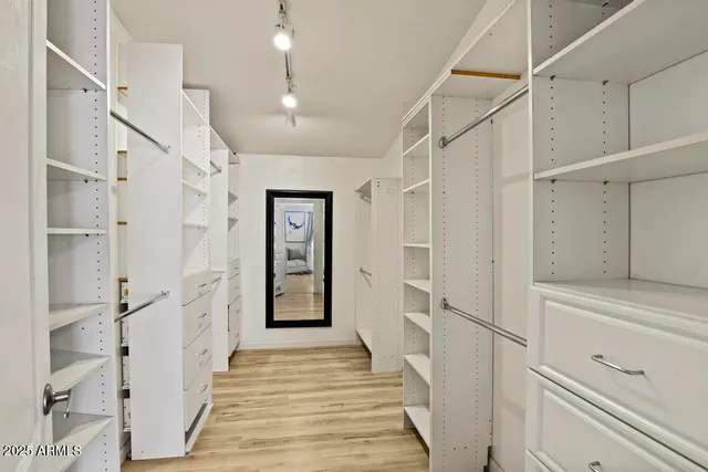 a bathroom with a granite countertop toilet a sink and a shower