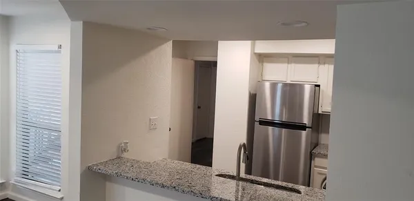 a view of a kitchen from the hallway
