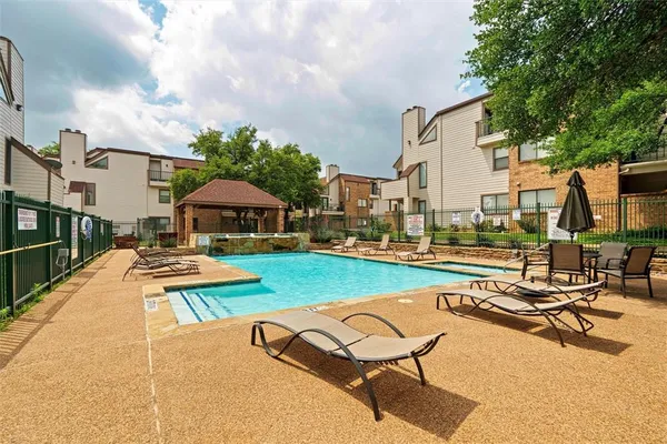 a view of a house with pool and chairs