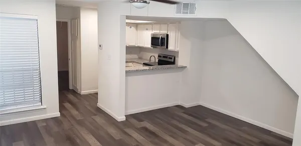 a view of kitchen and wooden floor