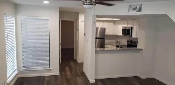a view of a kitchen from the hallway
