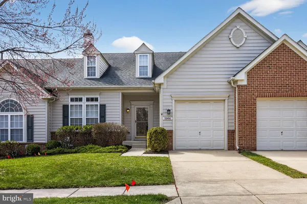 a front view of a house with a garden and garage