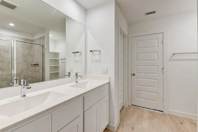 a bathroom with a double vanity sink and a mirror