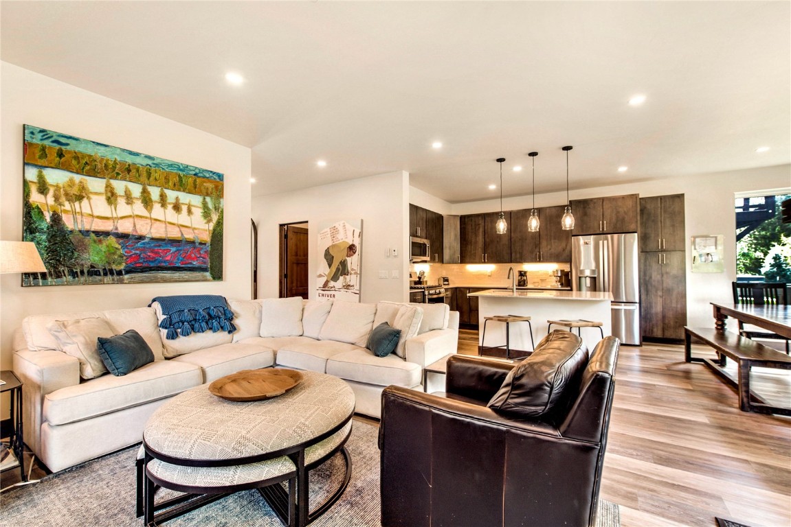 596 Fly Line Drive Silverthorne, CO 80498 - Photo 5 of 32 a living room with kitchen couches and kitchen view with wooden floor