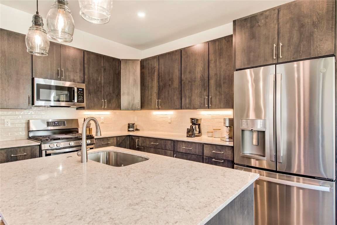 596 Fly Line Drive Silverthorne, CO 80498 - Photo 7 of 32 a kitchen with kitchen island a sink appliances and cabinets