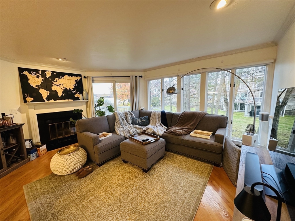 46 Pointe Rok Drive, Unit 46 Worcester, MA 01604 - Photo 11 of 23 a living room with furniture a fireplace and a flat screen tv