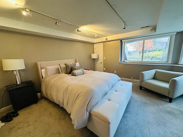a bedroom with a bed and a couch
