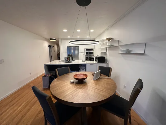 a view of a dining room with furniture and wooden floor