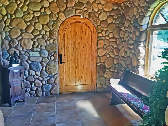 a view of entryway with a front door and wooden floor