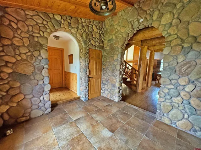 a dining room with lots of furniture and a rug