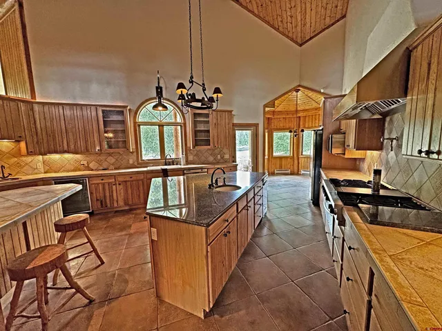 a kitchen with granite countertop a refrigerator and a stove