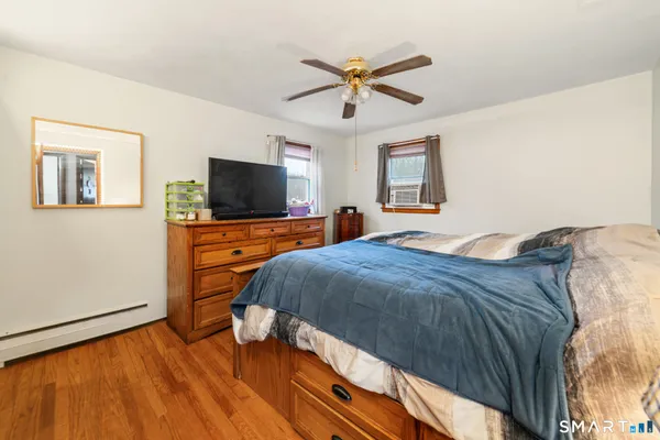 a bedroom with a bed and a flat screen tv