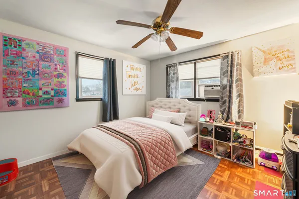 a bedroom with a bed cabinets and window