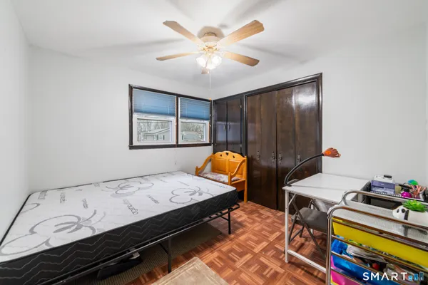 a bedroom with a bed and a chandelier