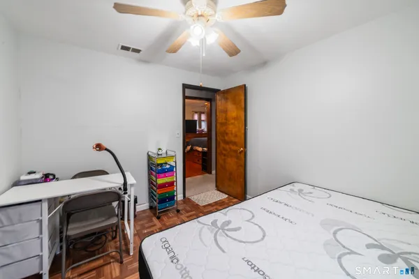 a bedroom with a bed and a chandelier