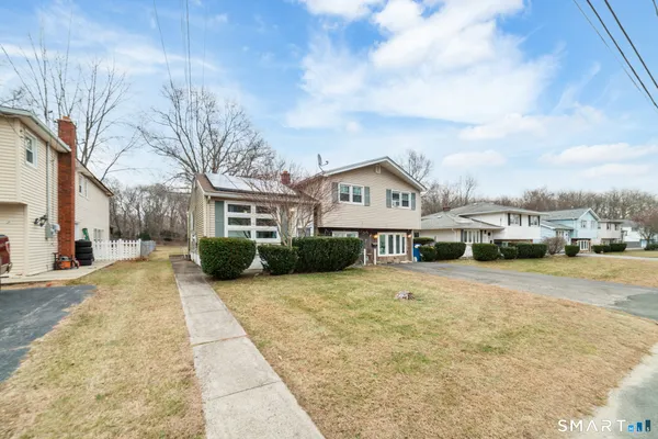 a view of a house next to a big yard