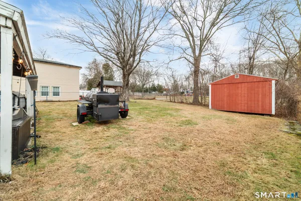 a backyard of a house with table and chairs