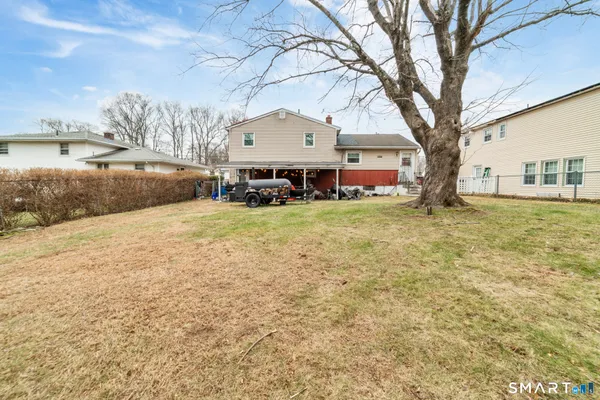 a view of a house with outdoor space and a yard
