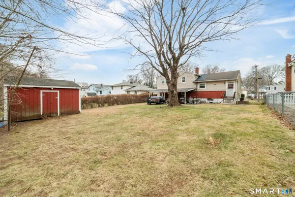 a view of a yard with a large tree