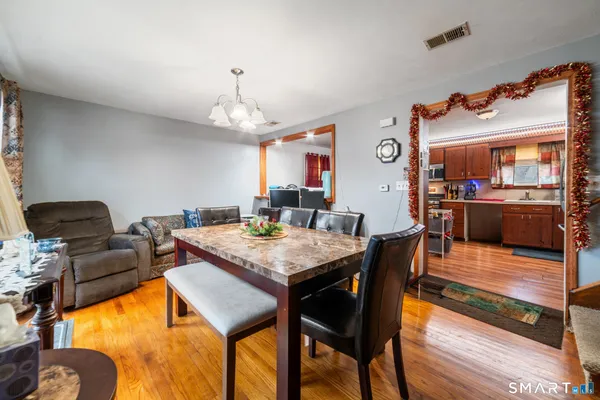a view of a dining room with furniture and wooden floor