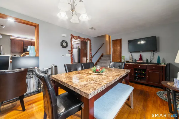 a view of a dining room with furniture and a flat screen tv
