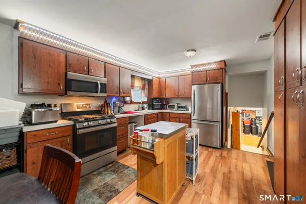 a kitchen with stainless steel appliances granite countertop a refrigerator stove and sink
