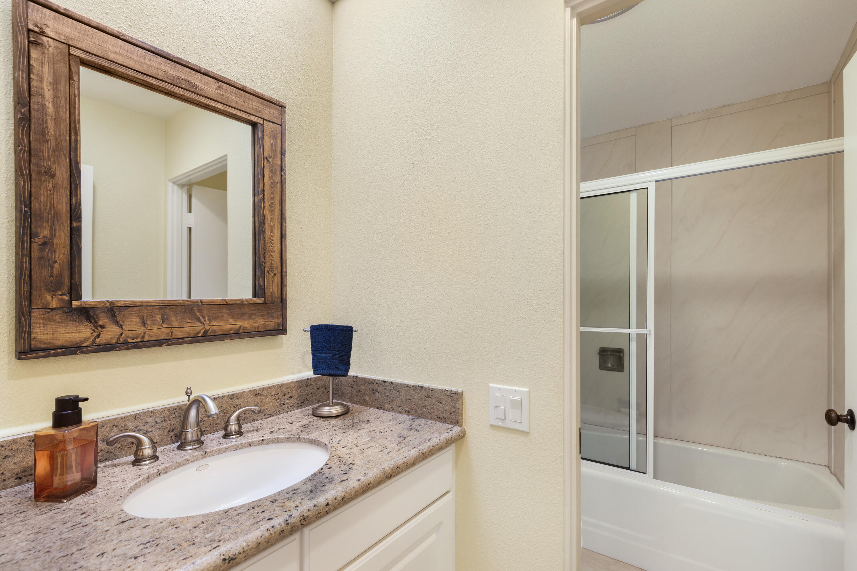 836 Inverness Drive Rancho Mirage, CA 92270 - Photo 16 of 29 a bathroom with a granite countertop sink mirror and a bathtub