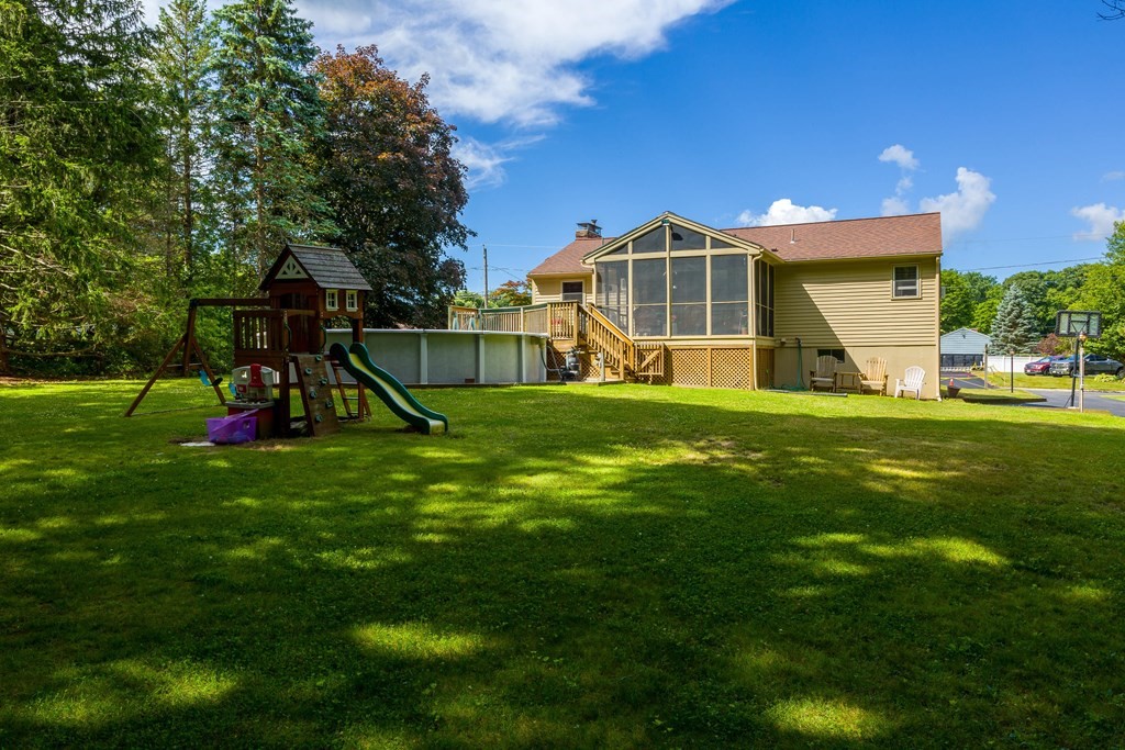 30 Heritage Road Sutton, MA 01590 - Photo 6 of 31 a view of a big house with a big yard and potted plants and a large tree