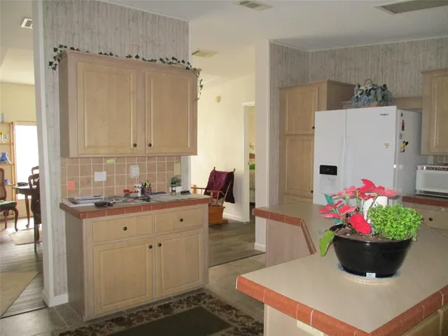 a view of a kitchen with an empty space and a window