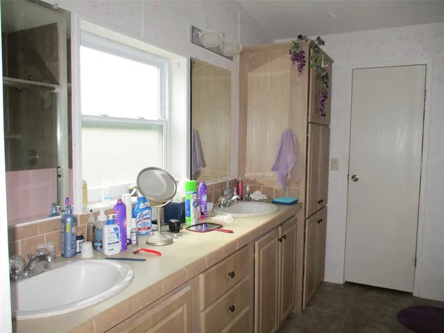a bathroom with a double vanity sink and a mirror
