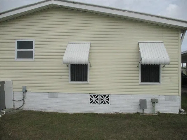 a view of a brick house with a yard