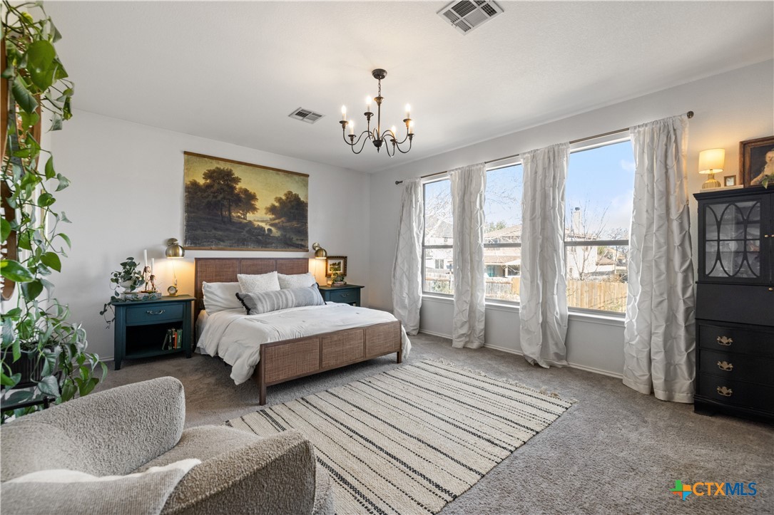 723 Tumbleweed Trail Temple, TX 76502 - Photo 16 of 38 a spacious bedroom with a bed and a couch