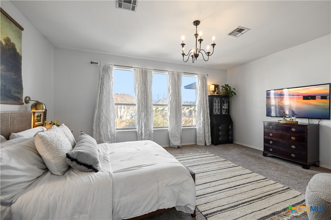 723 Tumbleweed Trail Temple, TX 76502 - Photo 18 of 38 a bedroom with a bed and a flat screen tv